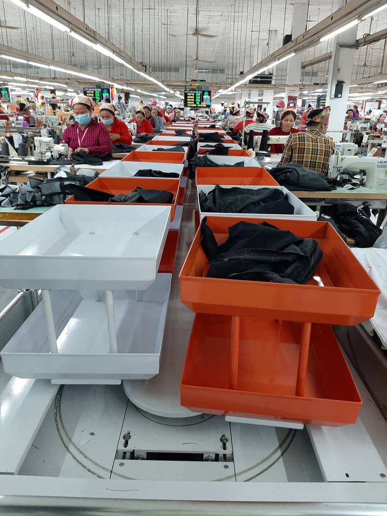 stitched_pieces_forwarded_through_automated_conveyor